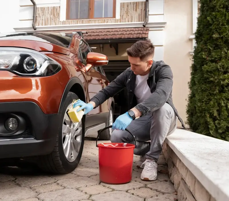 Lavage auto à domicile Saint-Symphorien-des-Bruyères : professionnel intervenant sur un véhicule